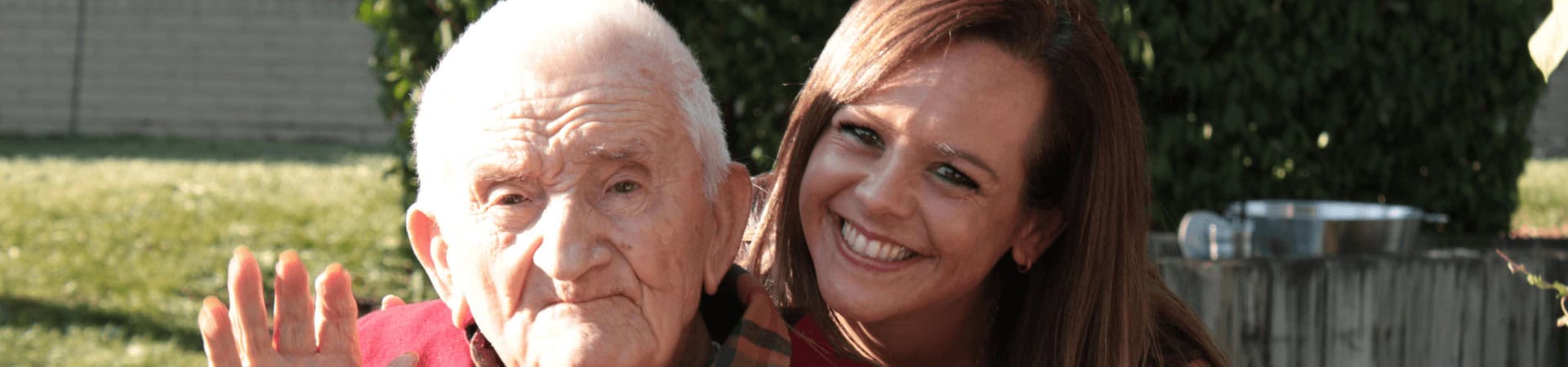 Senior Citizen And Younger Woman Sit Together